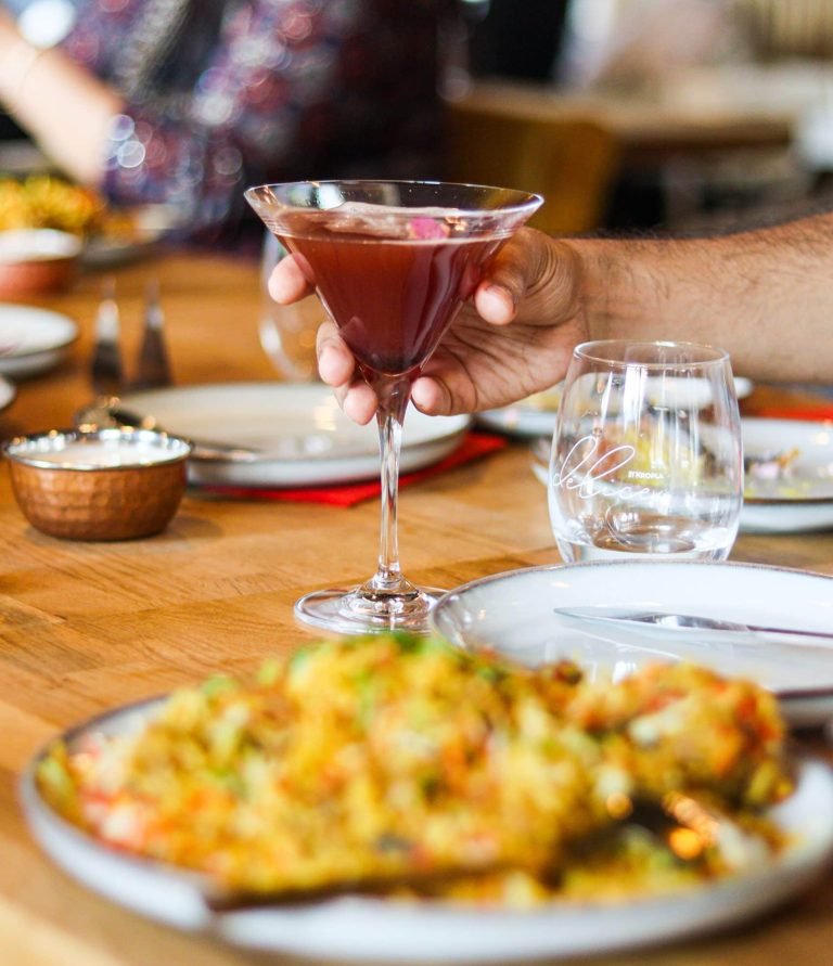 A set of colorful cocktails in different glasses, decorated with fruits and herbs. A refreshing and exotic drink option in Indian and Thai cuisine.